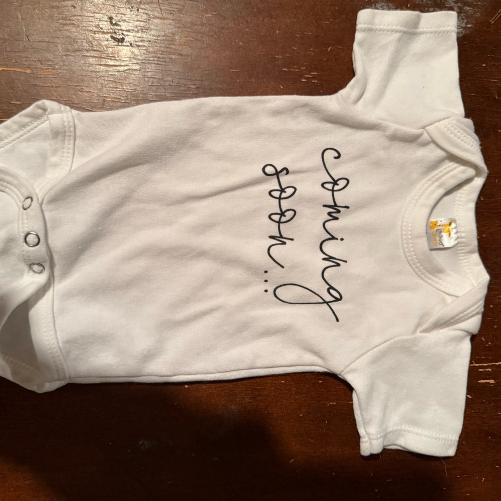 White Baby Onesie with 'Coming Soon' Text